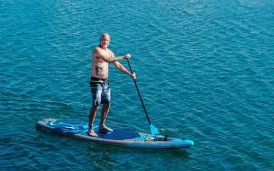 photo of man Stand Up Paddleboarding